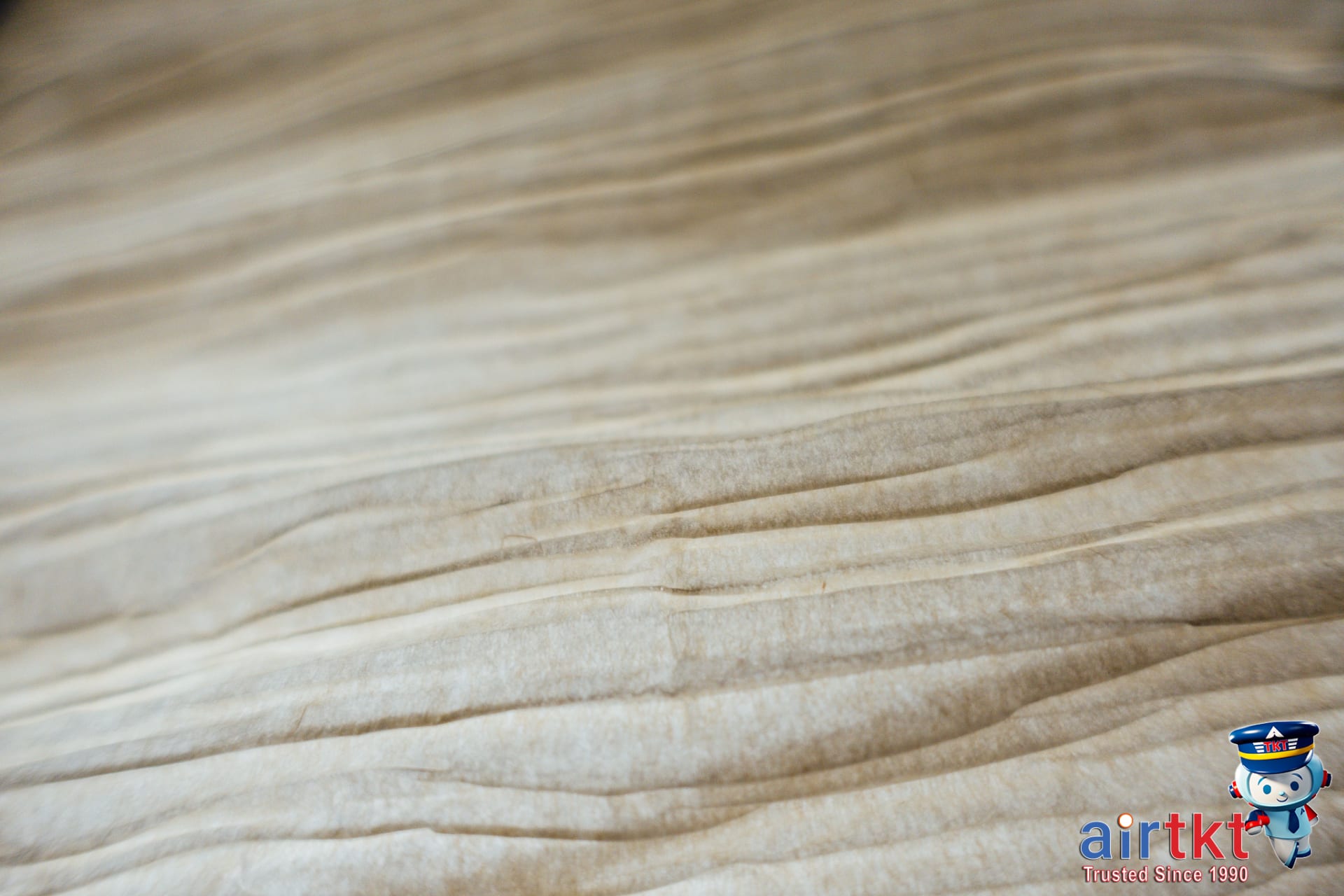 Neatly folded thermal and mid layers for winter packing on wooden surface