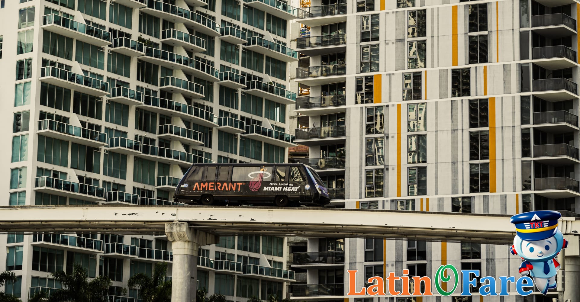 Miami Metromover suspended above busy streets and palm trees in downtown area