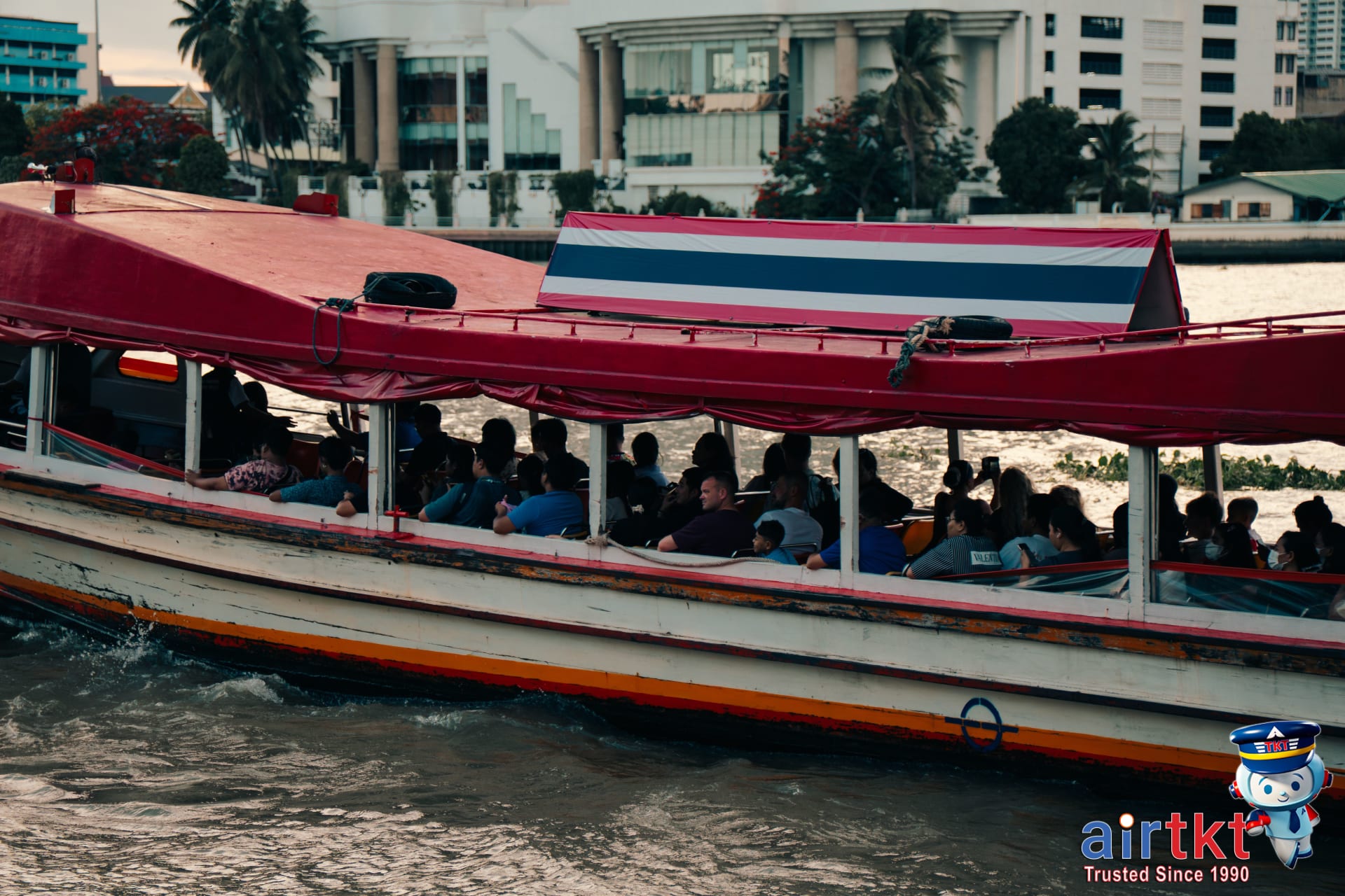 Chao Phraya river boats docking at busy Bangkok pier with passengers