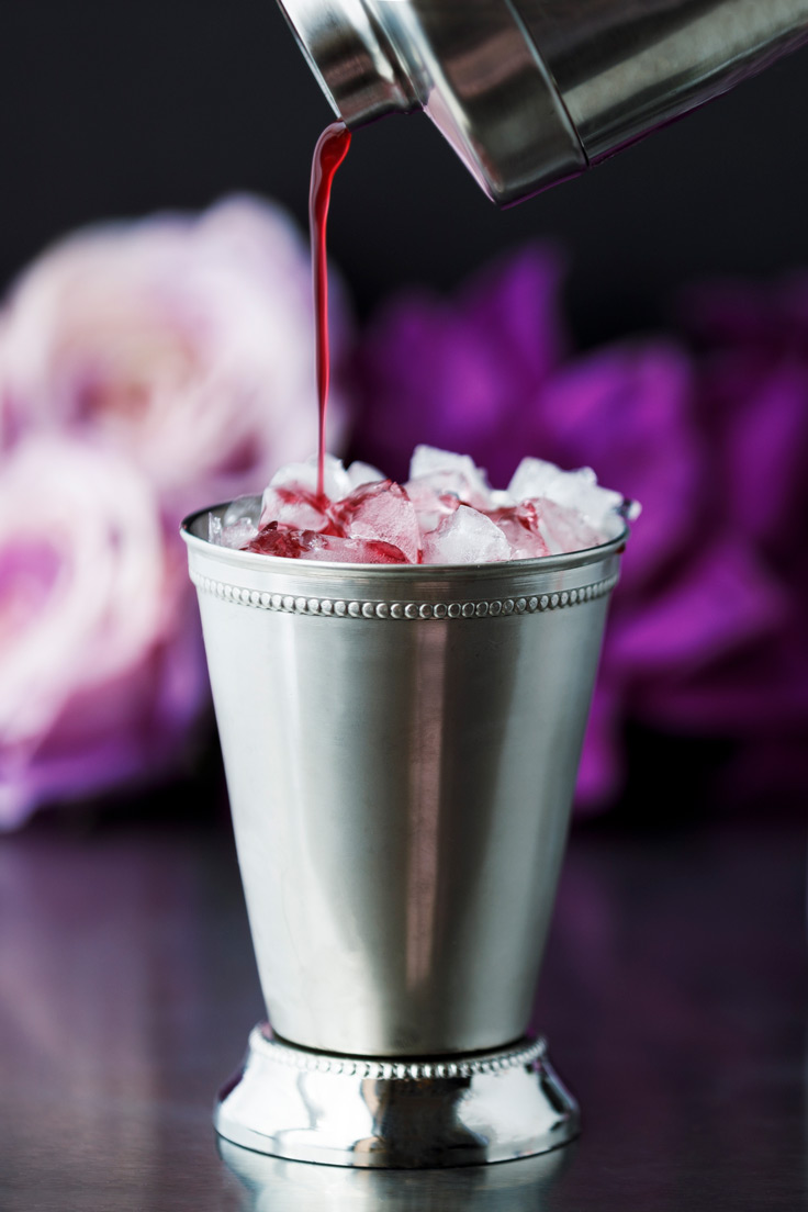 pouring Amoretti's Blackberry Mint Julep Recipe
