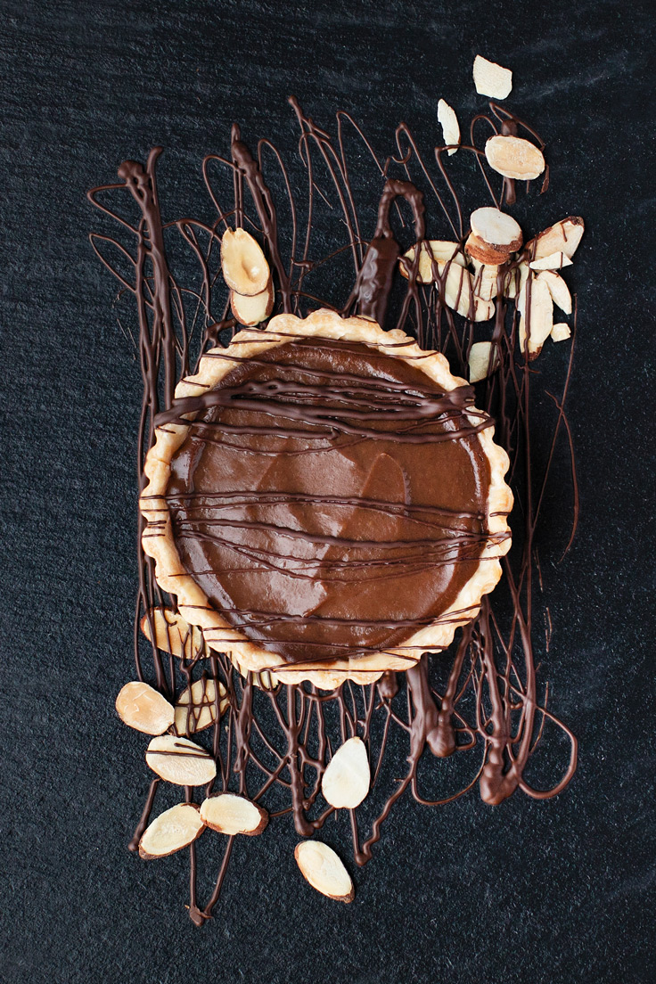Amoretti Almond Dark Chocolate Cream Pie Recipe with chocolate drizzle and sliced almonds