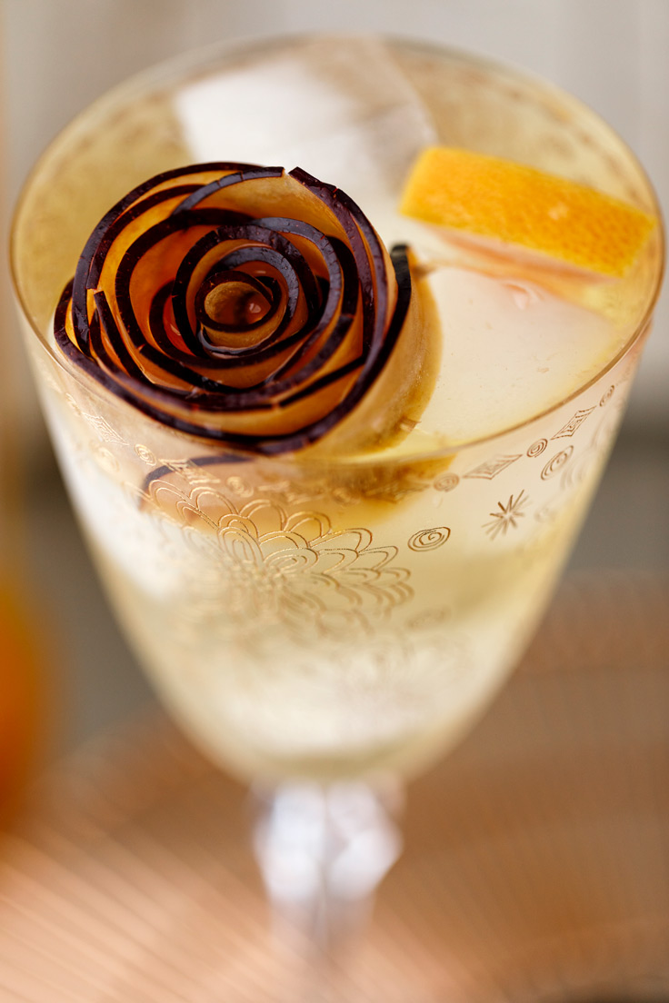 A fancy plum garnish on Amoretti Summer Sangria Recipe with stone fruits and citrus