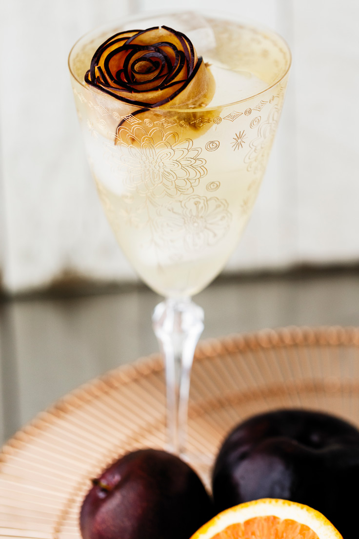A glass of Amoretti Summer Sangria Recipe with stone fruits and citrus