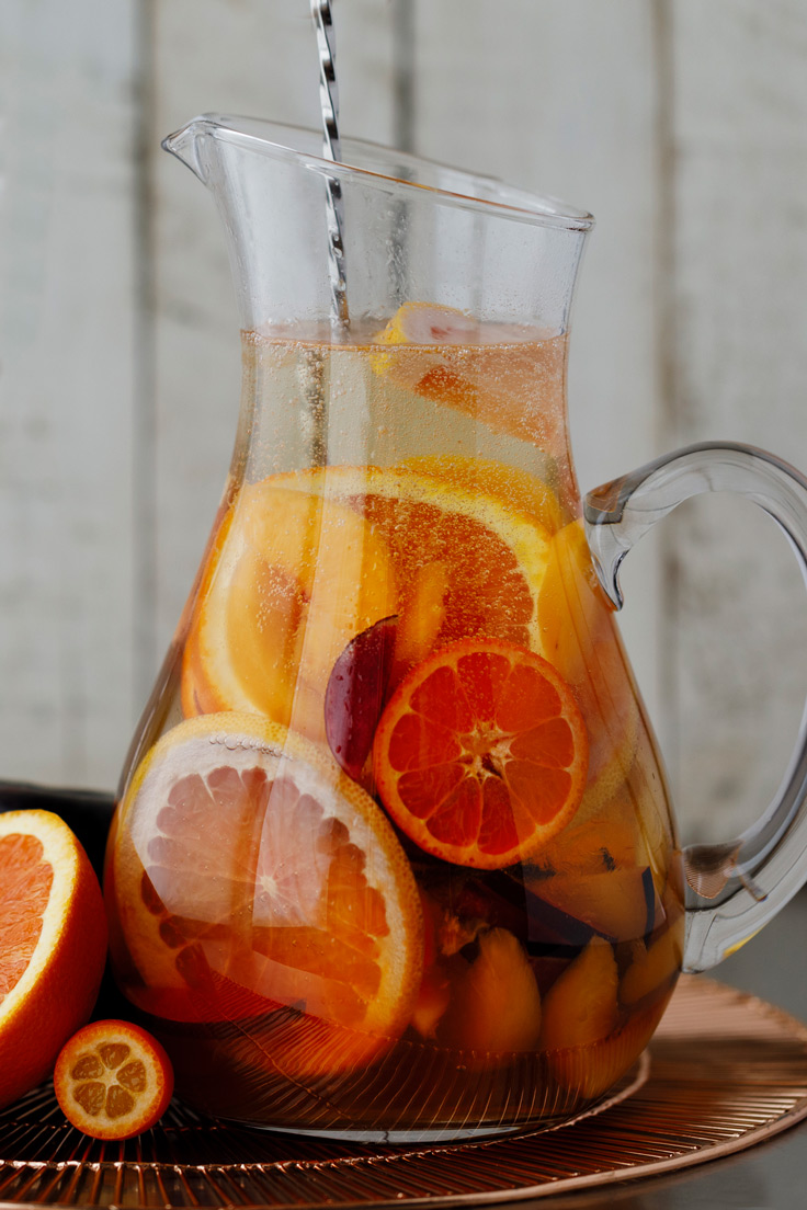 Amoretti Summer Sangria Recipe with stone fruits and citrus, a quick stir to blend flavors