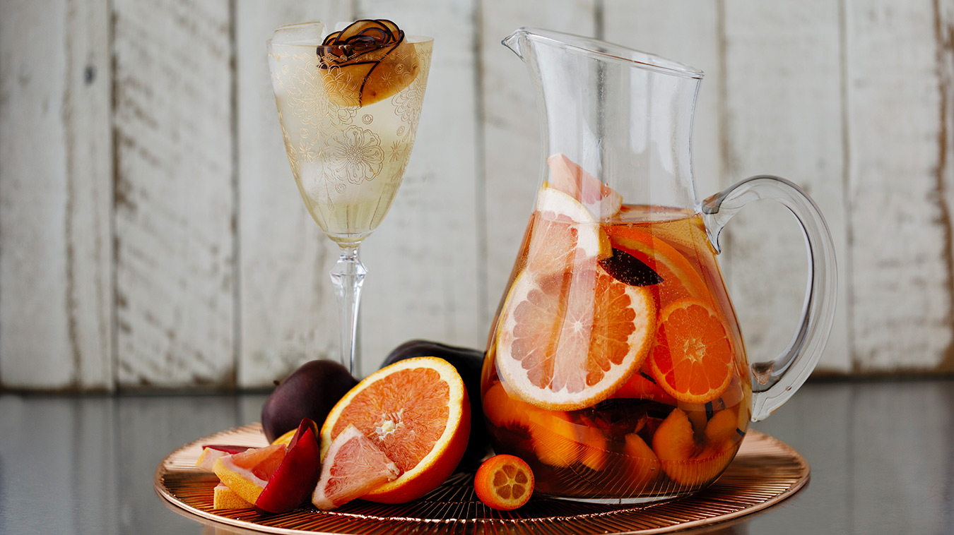 Amoretti Recipe: Summer Sangria with stone fruits and citrus, garnished with a plum rose