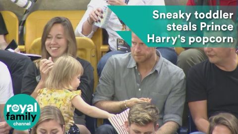 Sneaky toddler steals Prince Harry's popcorn Sneaky toddler steals Prince Harry's popcorn