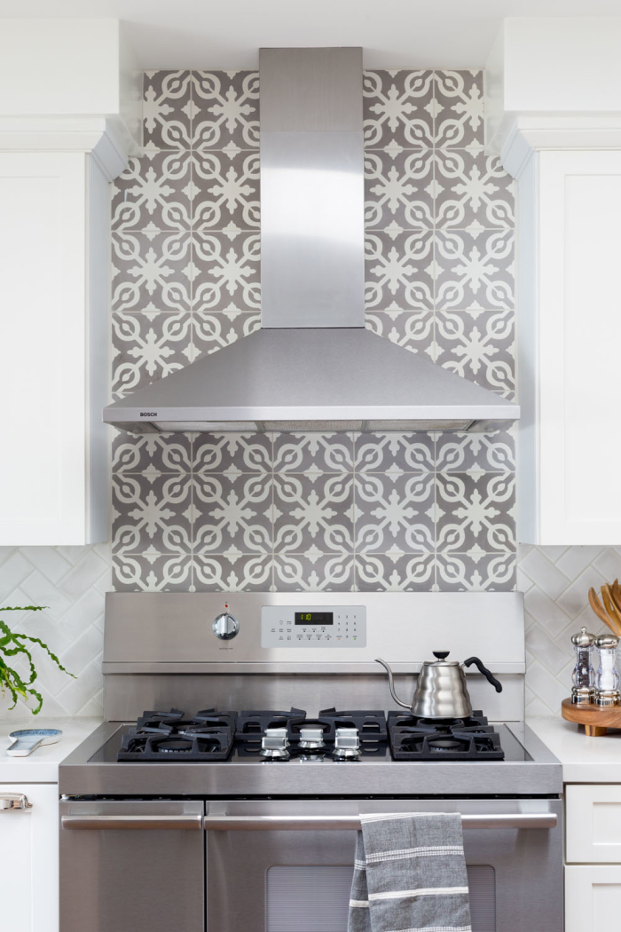 A good way to bring in a decorative tile is above the stove. Designer Marissa Cramer chose our Remy 8x8 cement tile in Soffia