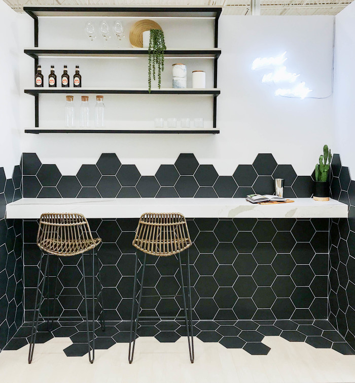 Wall: Costa Allegra 8in hexagon porcelain tile in Riverway | Floor: Barrique 4x24 wood-look porcelain tile in Blanc | Countertop: Sequel Quartz in polished 2cm Macaubas