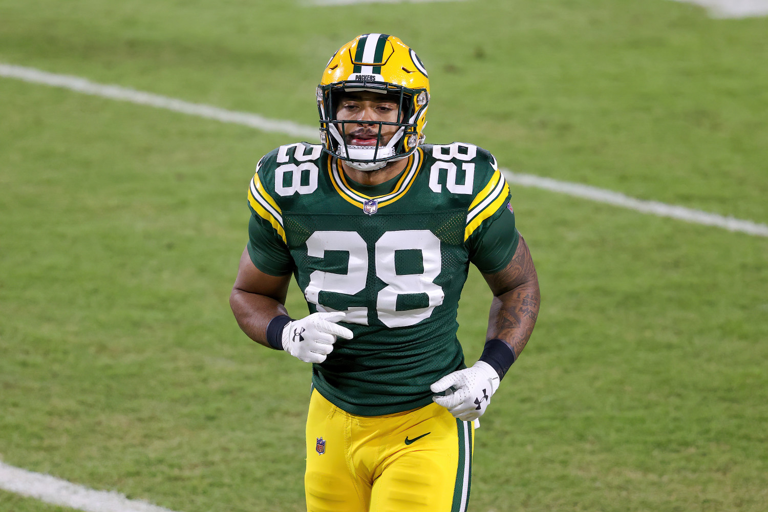 Green Bay Packers' AJ Dillon crushes a watermelon with his legs