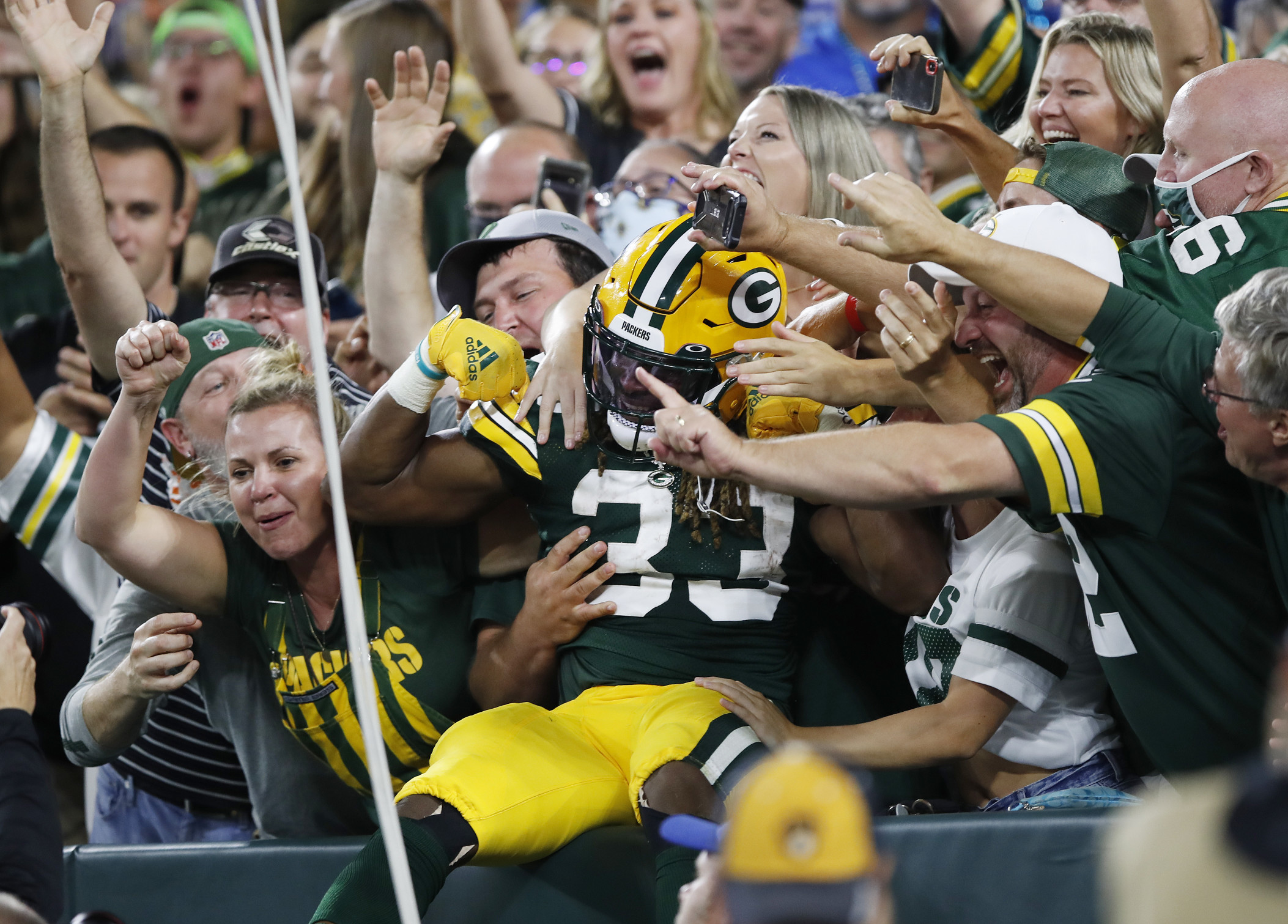 Lambeau Leap! Patrick Taylor celebrates after TD run