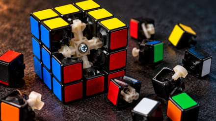 Close-up of a partially disassembled Rubik's Cube revealing its internal mechanism and colorful puzzle pieces, illustrating logic, creativity, and problem-solving.