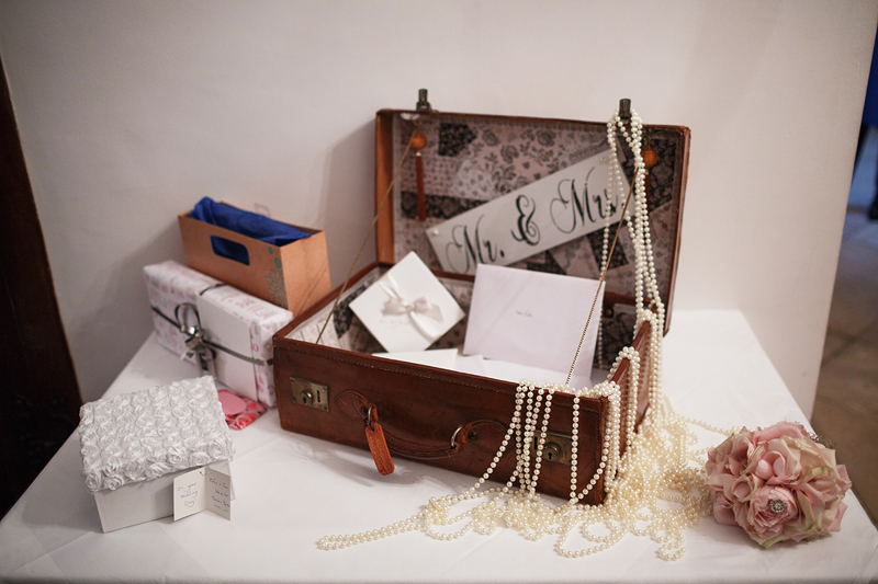 cards and gifts table with a suitcase 