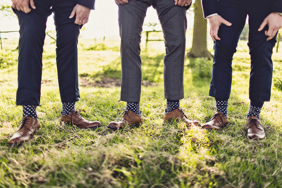 Bridebook.co.uk- ushers showing off matching polka dot socks