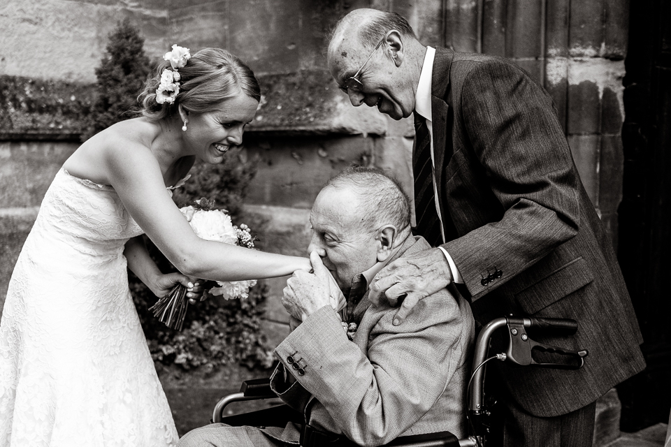 Bridebook.co.uk- bride having her hand kissed by grandfather