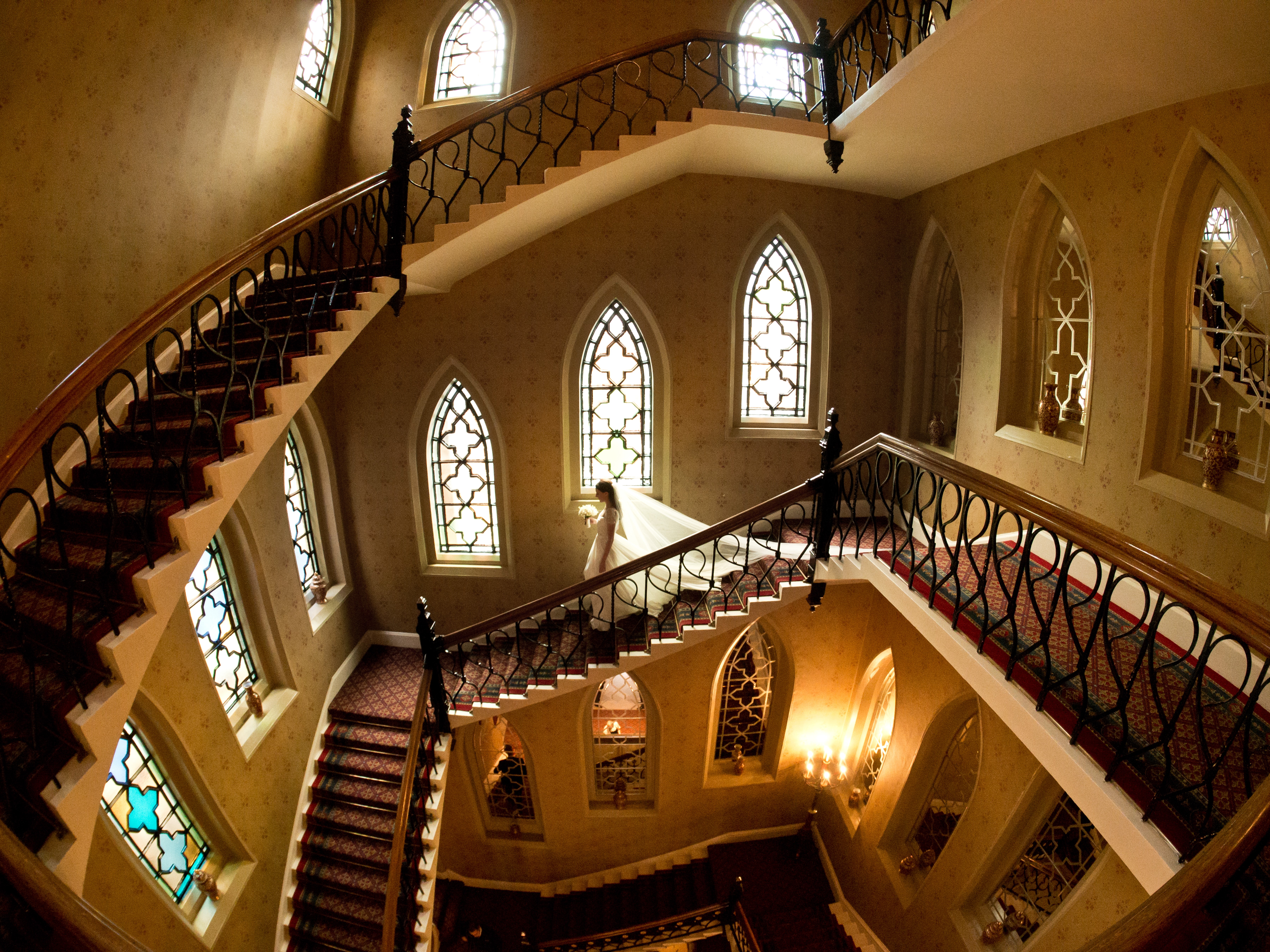 bridebook.co.uk photograph by john nassari of bride walking down stairs