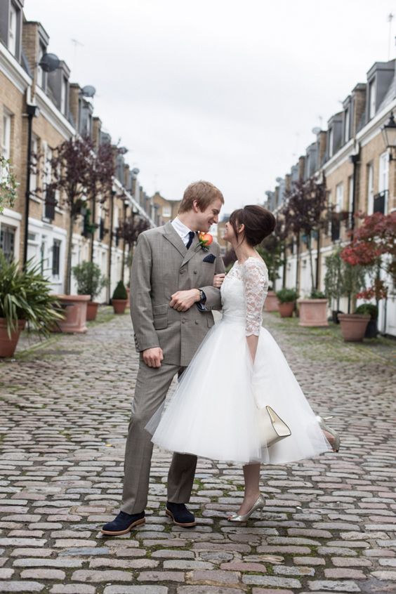 bridebook.co.uk London bride and groom with bride in a short wedding dress