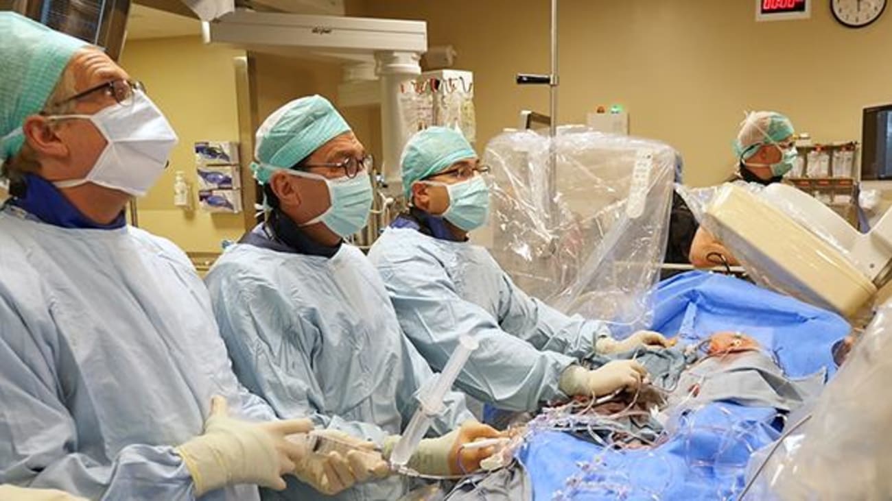basilica_team UW Medicine cardiologist Danny Dvir, center of frame, leads a team of UW Medicine heart specialists in performing a never-before-tried technique to replace a patient's failed artificial aortic valve.