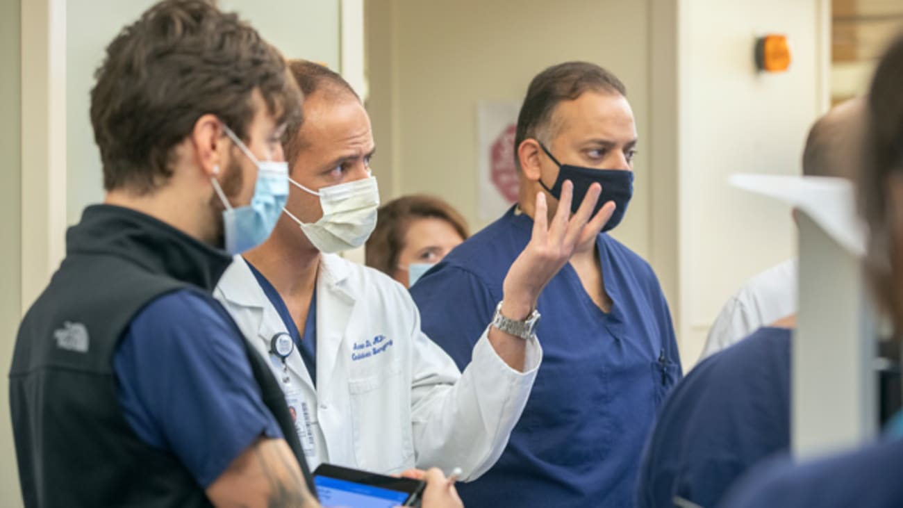 Arman Kilic, M.D., second from left, speaks during rounds in the cardiovascular intensive care unit at MUSC Health. Credit: Sarah Pack