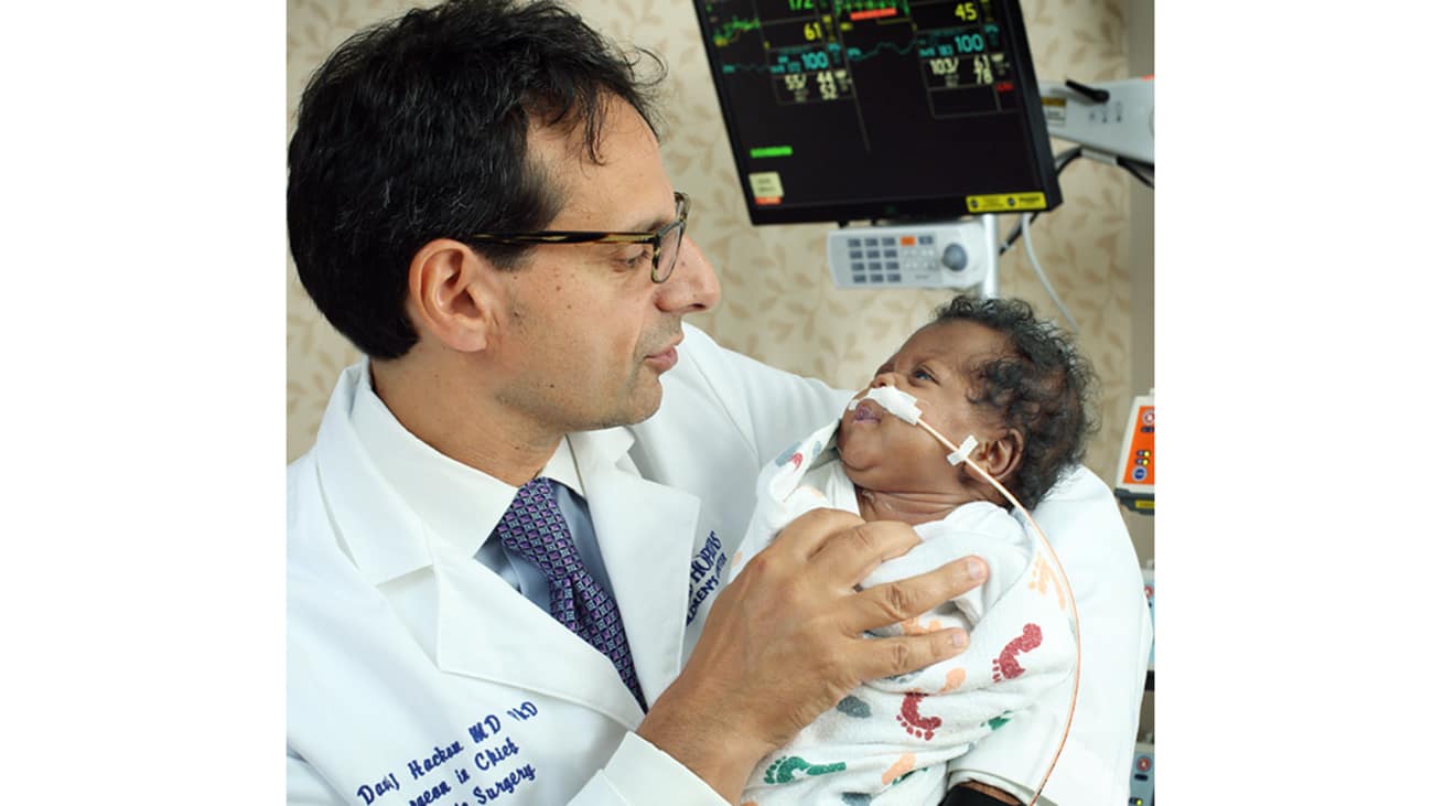 David Hackam, surgeon-in-chief of Johns Hopkins Children’s Center, examines a patient after a successful surgery and recovery.