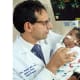 David Hackam, surgeon-in-chief of Johns Hopkins Children’s Center, examines a patient after a successful surgery and recovery.