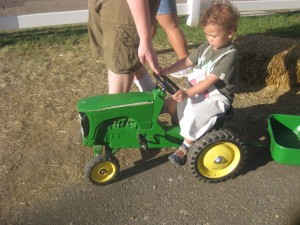 This was an unyielding tractor for Lincoln to pull (it also had a trailer attached to it). Since Lincoln is learning to ride on the Strider he is not used to pedals since he is learning balance on a 2 wheeler. We ended up having to cut the tractor ride short at the Little Farm Hands Exhibit.