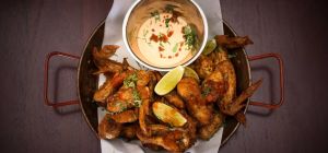 $15 Crispy Creole Chicken Wings at The Newport Hotel