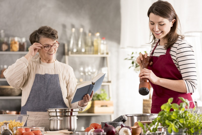 caregiver and senior cooking together