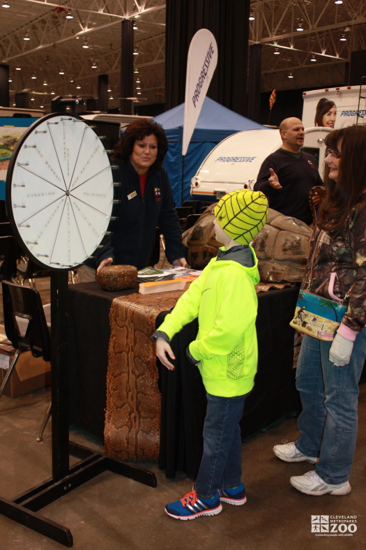 Cathleen Smith and kid awaiting prize from the Prize Wheel