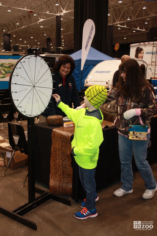 Cathleen Smith and kid spinning Prize Wheel- 2014 RV Show