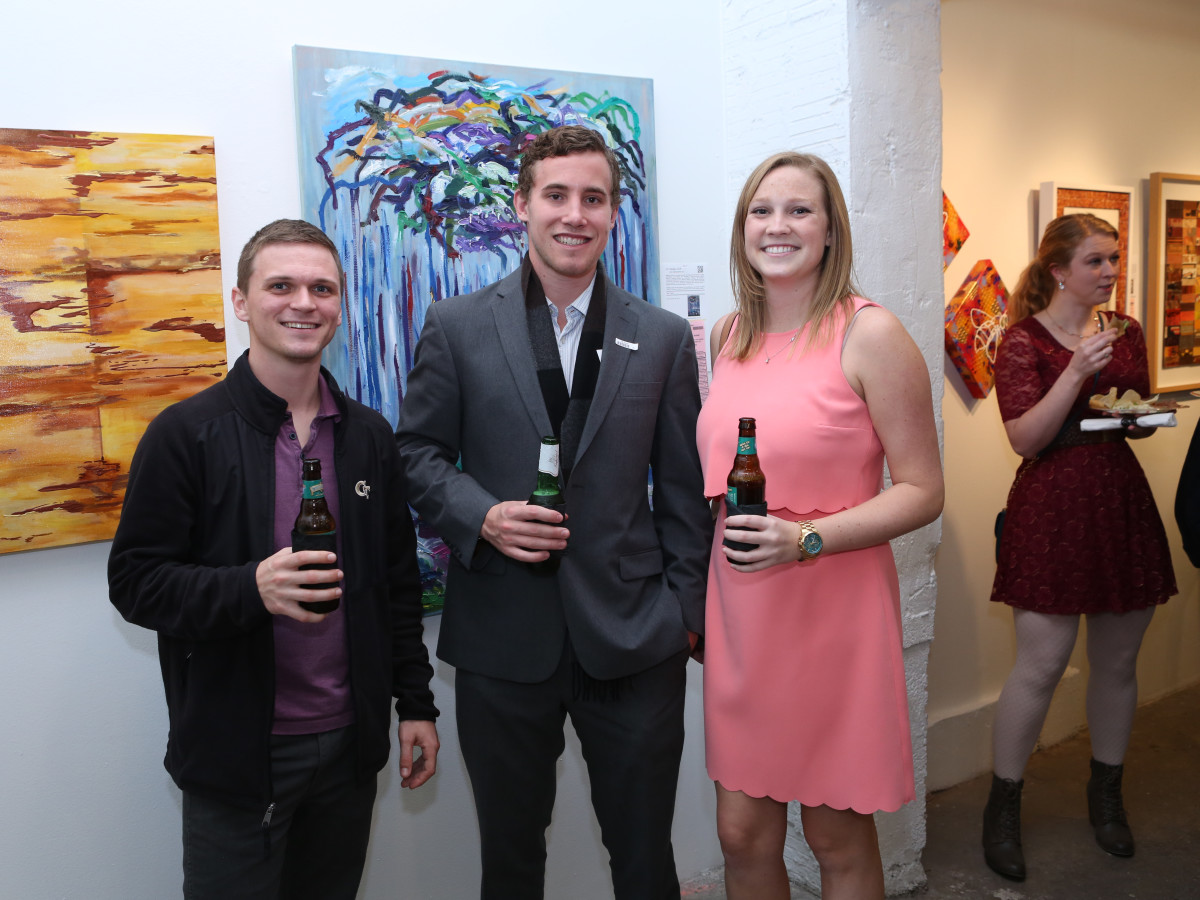Carl Trovallo, Brian Anderson, Meredith Kendrick take a moment from bidding on artwork to pose for a photo at the 19th annual Art on the Avenue