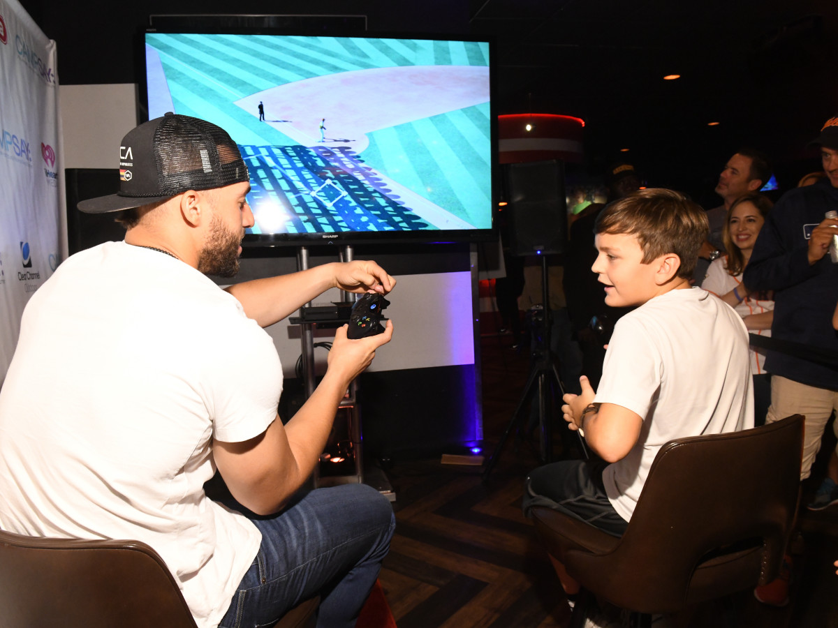 George Springer playing video game with auction winner