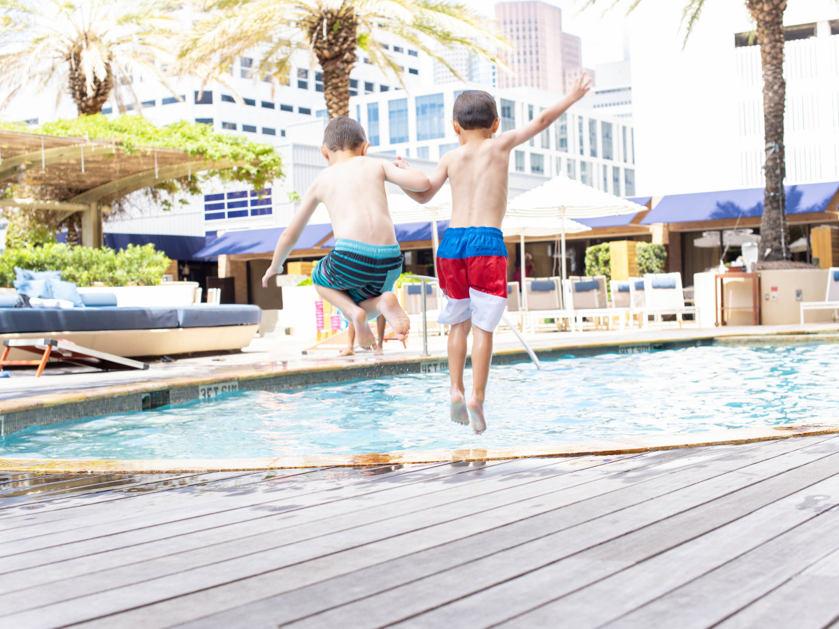 Kids jumping into the pool