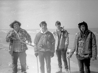 Chicago rock band Twin Peaks standing on a beach