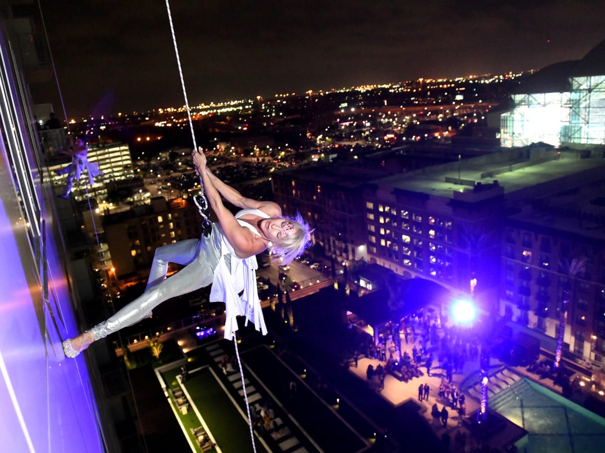 woman aerial performer side of wall