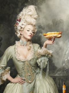 model dressed up as Marie Antoinette with a hot dog Austin Polo Club