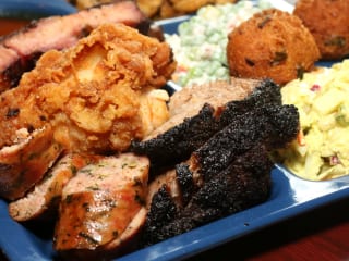 Plate of barbecue and sides at Slow Bone restaurant in Dallas