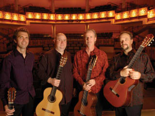 members of LA Guitar Quartet standing in a theater