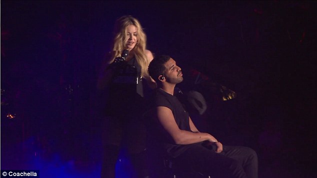 He didn't look too worried: The artist sat with arms folded as she went behind him