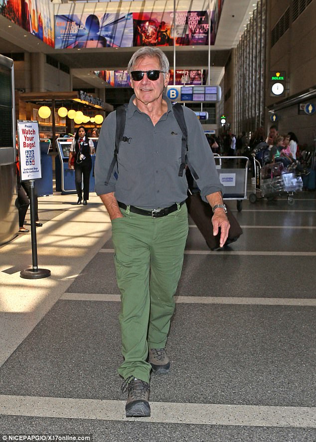 Family getaway: Harrison Ford led his wife Calista Flockhart and adopted son Liam across the concourse at LAX ready to jet away for a break