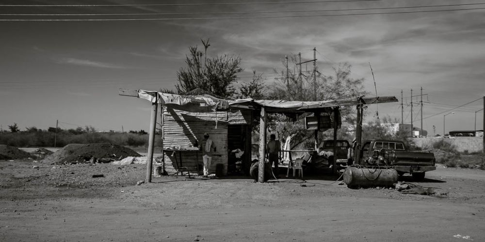 Highway 15 photo of men in a workshop.