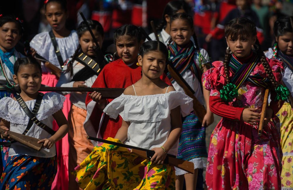 Soldaderas march with their toy guns in the Mexican Revolution Day parade in Ajijic, Jalisco, Mexico.