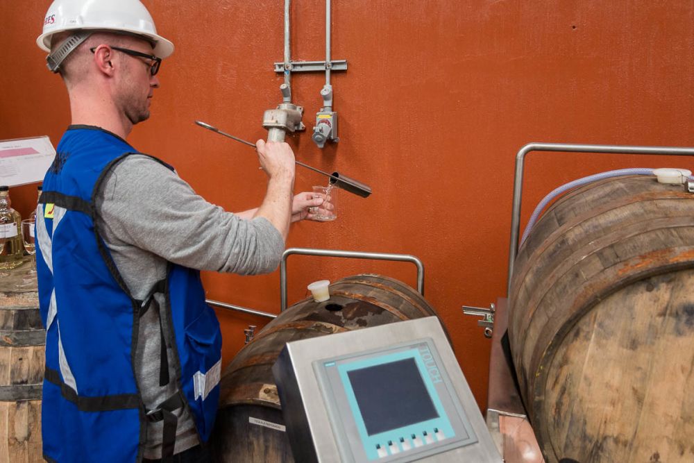 Filling up a beaker of reposado tequila at Tequila Cazadores in Arandas, Jalisco, Mexico.