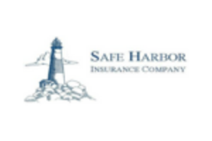 Silhouette of a lighthouse on rocks.