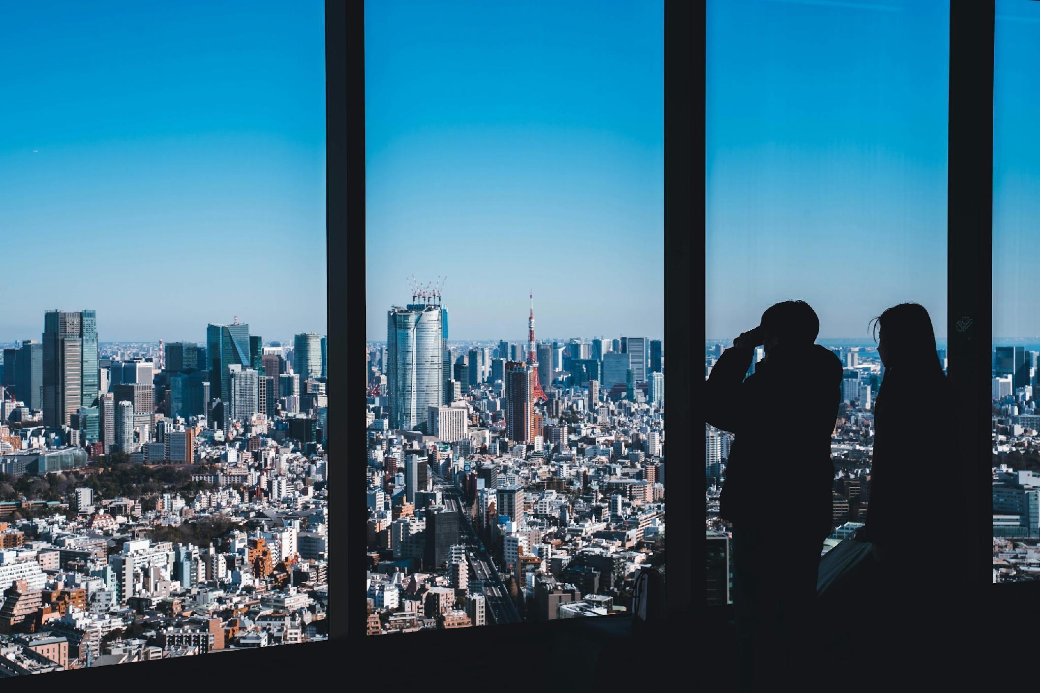 a group of people standing in front of a large city