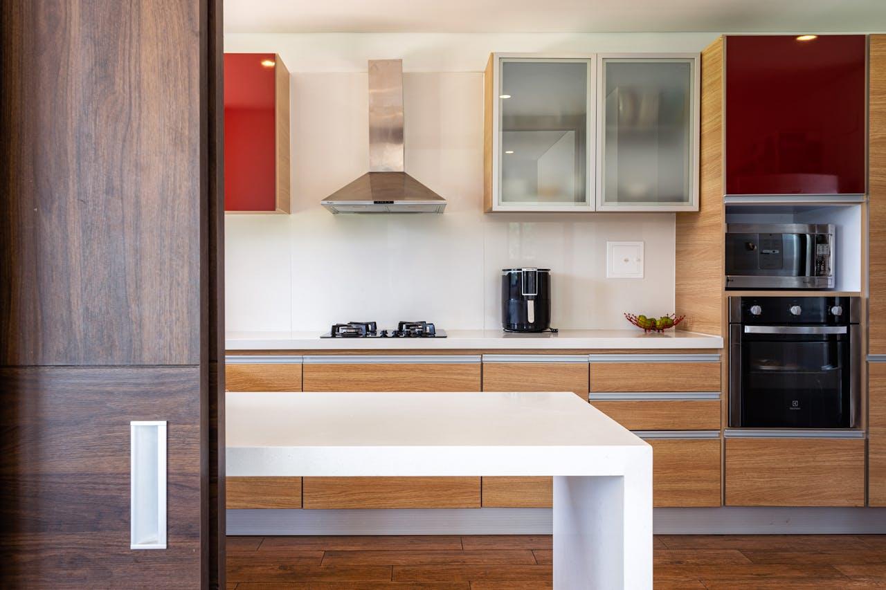 Stylish kitchen featuring wooden cabinets, glossy surfaces, and modern appliances.