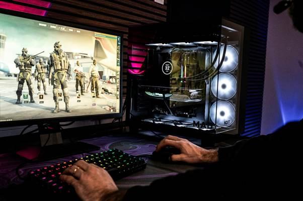 A man is playing a video game on his computer