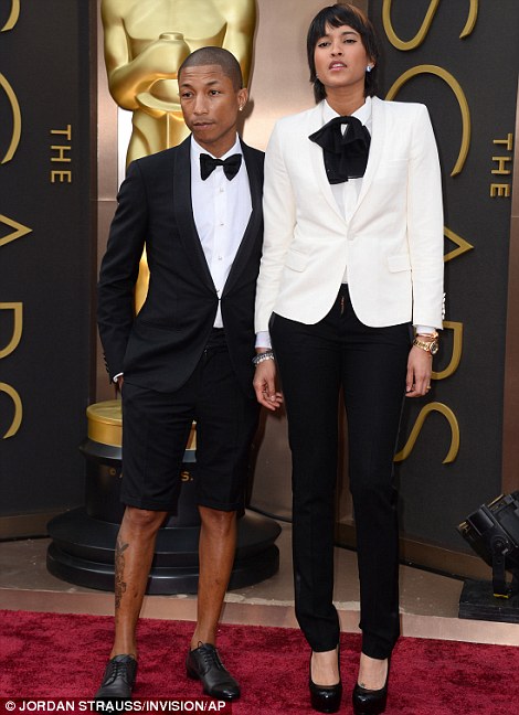 High jinks: Captain Phillips co-stars Barkhad Abdi and Faysal Ahmed had good fun on the red carpet while Pharrell Williams and Helen Lasichanh sported their own take on tuxedos