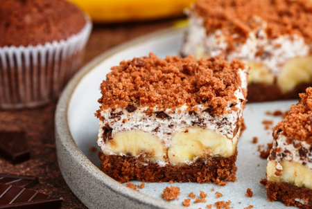 Delicious homemade chocolate dessert with banana, ricotta (cremcheese, mascarpone) and brownie. mole cake. portions of pie in a gray plate. selective focus