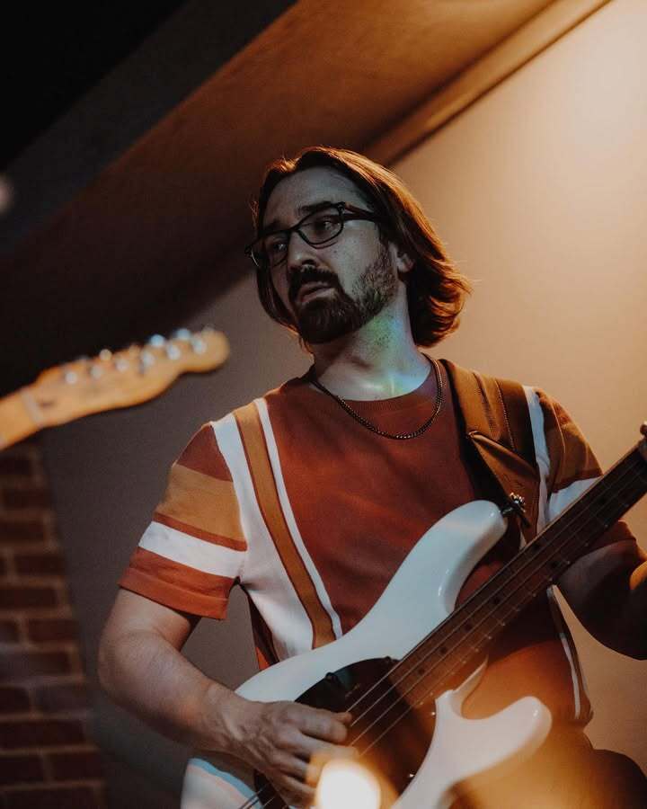 Nick playing the bass guitar.
