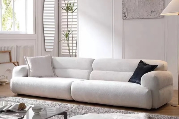 White fabric 4-seater sofa with a soft seat and backrest.
